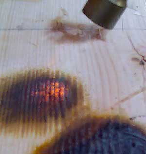 Applying flame to a treated surface - note that the wood will not catch fire